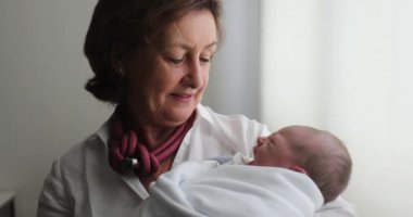 Grand-mother holding newborn baby
