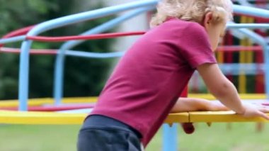 Child playground with carousel spinning round