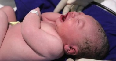 Newborn infant baby after birth, first seconds of life