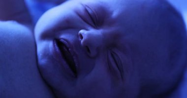 Newborn baby boy under phototherapy lamp. getting treated for jaundice