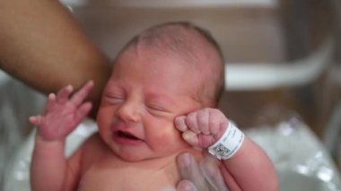 Newborn baby taking a bath for first time at the hospital