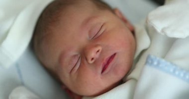 Newborn infant baby asleep at hospital in first day of life