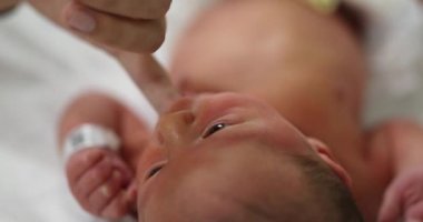 Newborn baby suckling on finger, calming effect on infant