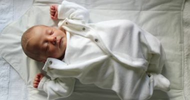 Newborn infant baby asleep, first day of life of baby sleeping
