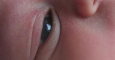 Macro closeup of newborn baby eye observing world learning about life
