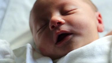 Newborn baby sleeping, infant in first day of life asleep