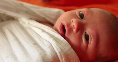 Playing Peekaboo with newborn baby and towel