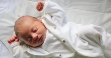 Newborn baby asleep during first day of life