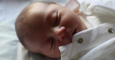 Newborn baby falling asleep, first day of life