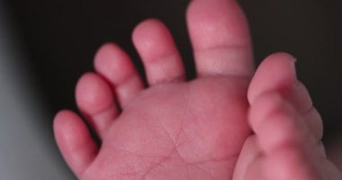 Tiny newborn baby toes and feet first days of life