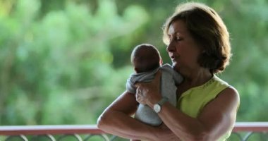 Grand parent holding baby infant