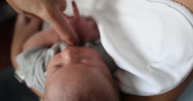 Parent holding newborn baby infant in arms first month of life