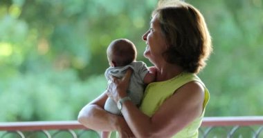 Grand-parent holding newborn baby infant portrait