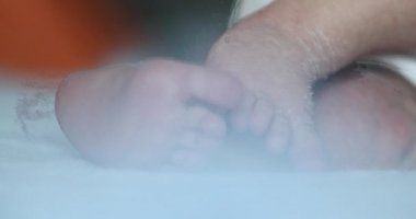 Close-up of baby feet playing