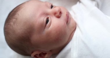 Cute newborn baby yawning during first days of life