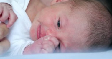 Cute newborn baby lying in bed, first week of life