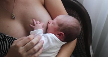 Mother breastfeeding newborn baby infant