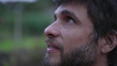 Man looking up at sky smiling having HOPE and FAITH. Person in 30s feeling the presence of GOD feeling FREEDOM