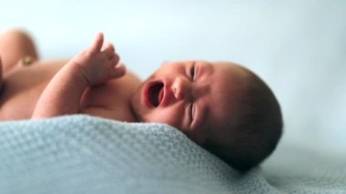 newborn baby crying portrait infant closeup face and body