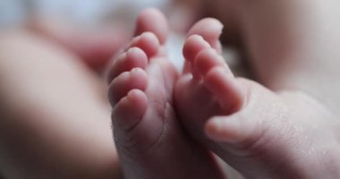 Newborn baby feet together, infant foot first week of life