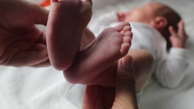Mother showing newborn baby infant feet