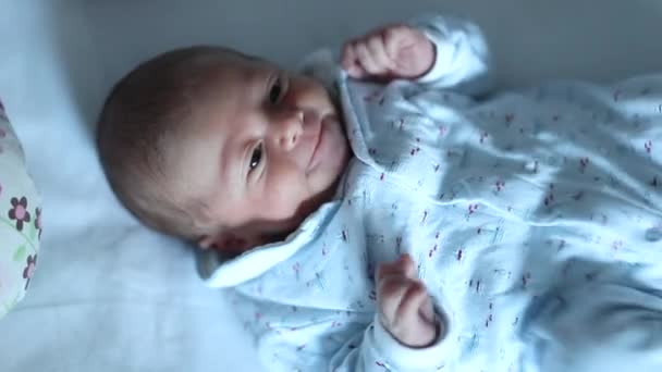 Upset Newborn Baby Laying Bed Doing Grimaces — Stock Video
