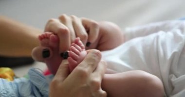 Playing with newborn baby feet and foot