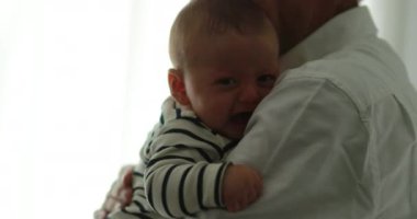 Grandparent holding grandson baby infant