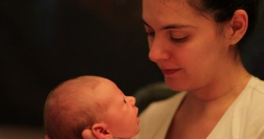 Candid motherly love kissing infant baby newborn casual