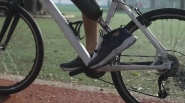 Man using his prosthetic leg while riding a bike