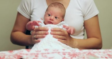 Mother holding newborn baby first month of life portrait