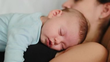 Adorable newborn baby sleeping on mother chest authentic infant asleep