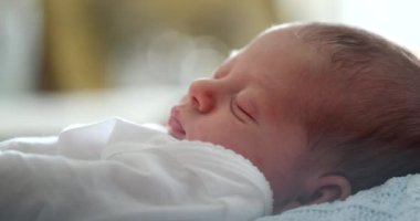 Newborn baby calmly asleep in first month of life