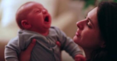Mother trying to console crying newborn baby