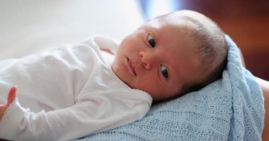 Close-up of newborn baby infant face awake first month of life