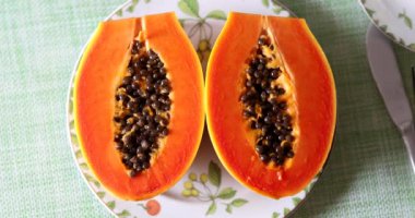 Two fresh papaya fruits on plate