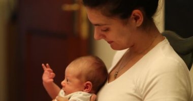 Candid motherly love kissing infant baby newborn casual