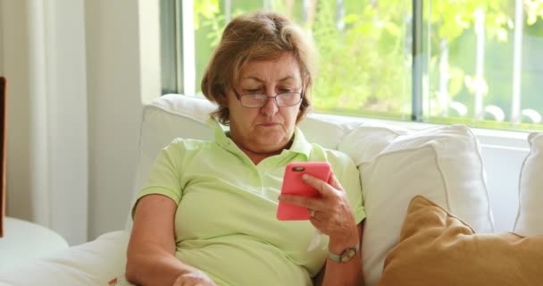Senior Older Woman Holding Cellphone Device Removing Reading Glasses Thinking — Stok video