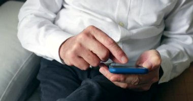 Older man using cellphone at home senior elder man touching smartphone screen