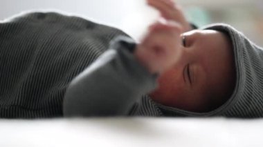 Cute Baby wearing woodie clothing layed in bed