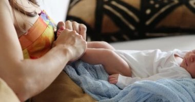 Playing with newborn baby infant toddler first month of life