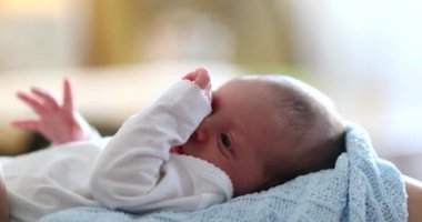 Adorable newborn baby infant waking up from nap