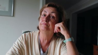 Tired Older woman rubbing eye with hand in the morning