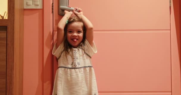 Small Girl Child Holding Door Knob Opening Front Door Waiting — Vídeo de Stock