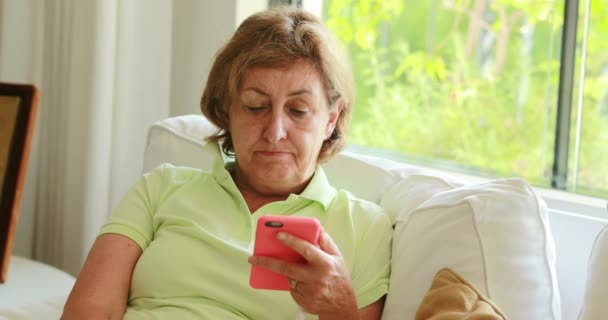 Thoughtful Candid Older Senior Woman Holding Smartphone Device Seated Home — Stok video