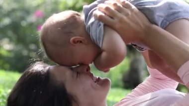 Beautiful mom and baby love and affection candid interaction outside in nature
