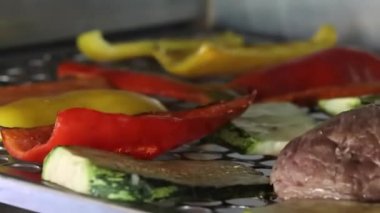 Vegetables and meat on grill cooking