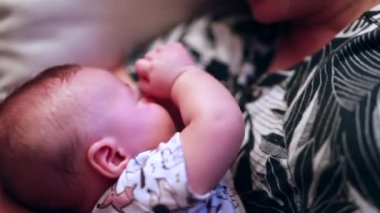 Casual candid mother with baby infant toddler in sofa