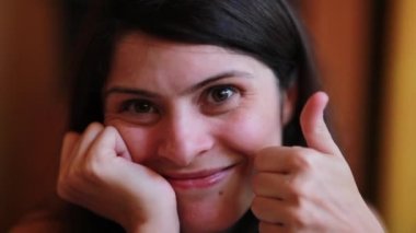 Funny pretty woman giving thumb up and posing for camera