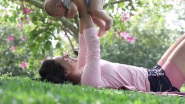 Beautiful mom and baby love and affection candid interaction outside in nature